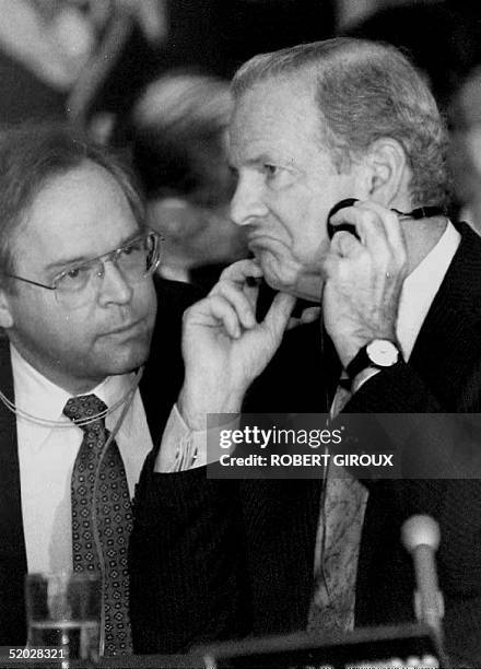 Secretary of State James Baker reacts to comments by Bernard Aronson, his assistant secretary of state for Latin America, 13 April 1992 during a...