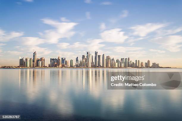 doha modern city reflected in the sea, qatar - doha foto e immagini stock