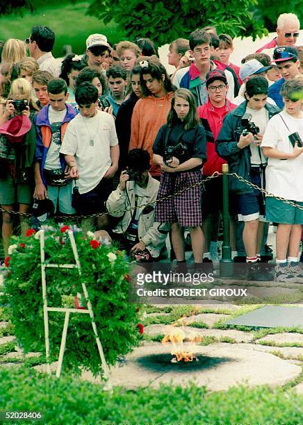 People gather 29 May in front of the gravesite of John F. Kennedy, the 35th president of the U.S., after a wreath-laying ceremony commemorating...