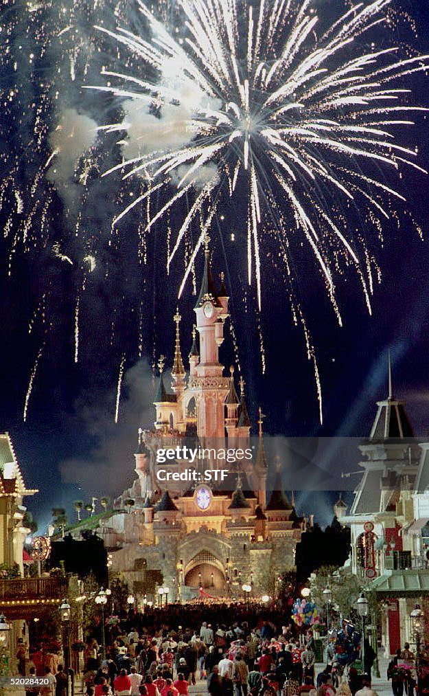 Spectators admire fireworks over Sleeping Beauty's