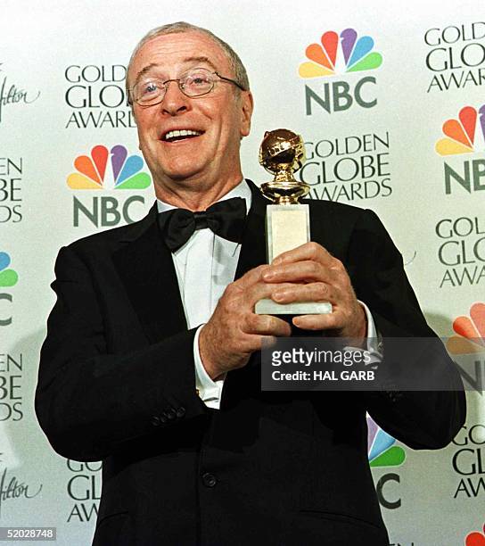 British actor Michael Caine holds his Golden Globe awards for Best Actor in the Comedy category for his role in the film "Little Voice" at the 56th...