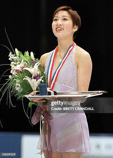 Michelle Kwan from Los Angeles, California celebrates her first place win in the Championship Ladies Free Program 13 February in the State Farm U.S....