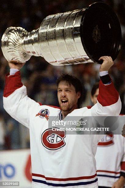 Stanley Cup Most Valuable Player Patrick Roy of the Montreal Canadiens holds the cup over his head after Montreal defeated the Los Angeles Kings 4-1...