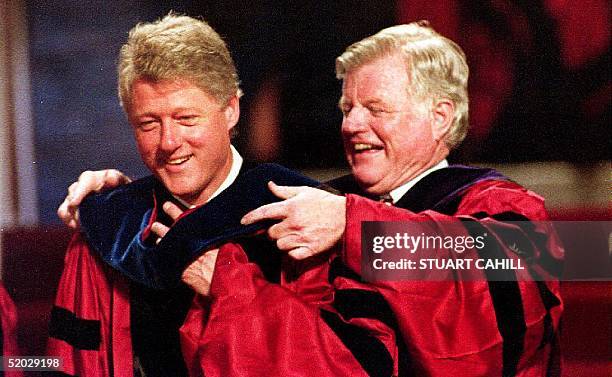 President Bill Clinton is hooded by Senator Edward Kennedy , D-Mass., while receiving an honorary degree from Northeastern University 19 June, 1993...