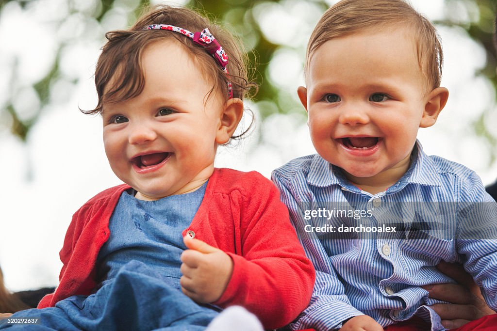 Twin baby smiling for the camera