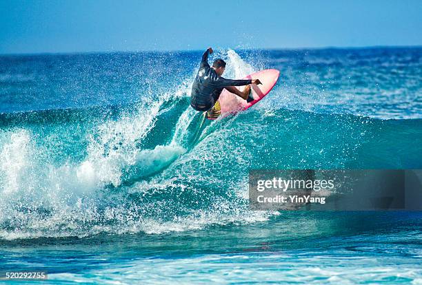 surfing in the beach of kauai hawaii horizontal - kauai stock pictures, royalty-free photos & images