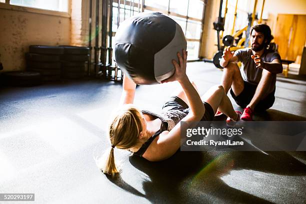 ab crunches with medicine ball - medicine ball stock pictures, royalty-free photos & images