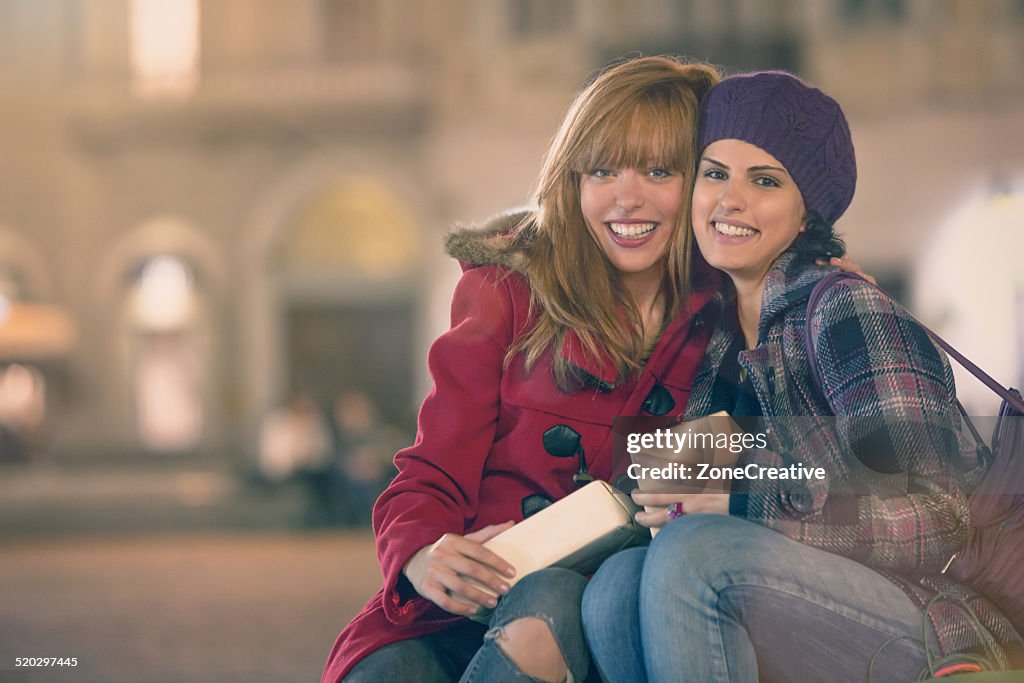 Young couple friends exchange christmas gifts outdoor