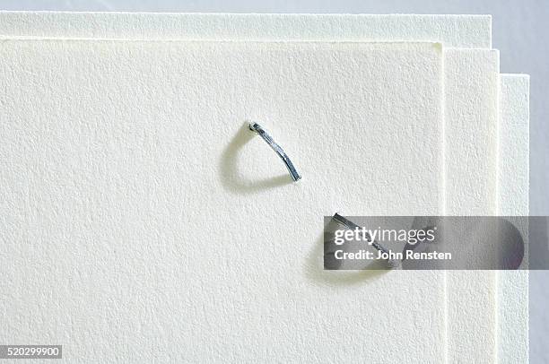 close-up of stapled paper - stapel stock pictures, royalty-free photos & images