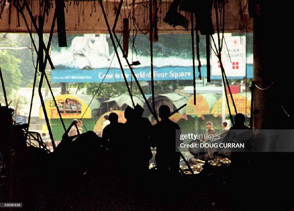 Officials inspect bomb damage in the basement of t
