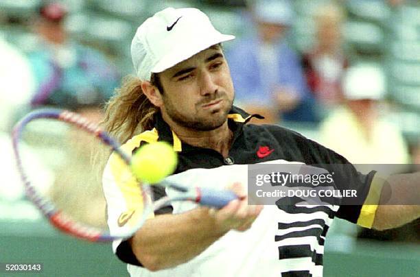 Andre Agassi of the U.S. Hits a forehand to Jason Stoltenberg of Australia in first set action at the Lipton International Championships before rain...