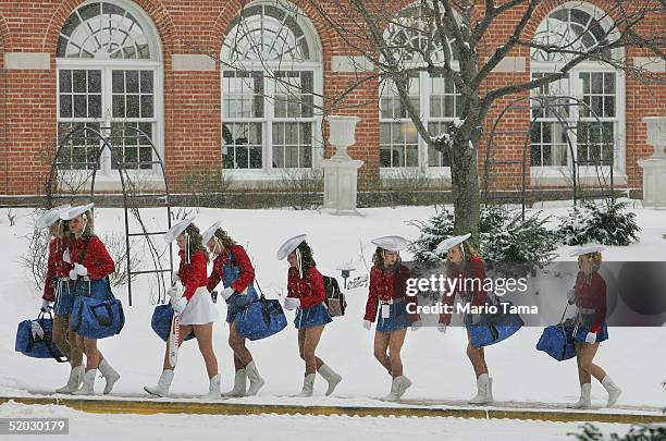 Members of the Kilgore College, Texas Rangerettes walk through the snow as they arrive at the Marriott Wardman Park Hotel for the Black Tie 'n Boots...