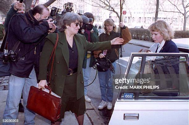 Actress Mia Farrow is escorted past photographers 26 March 1993 by her attorney Eleanor Alter as she heads into court for another day of testimony in...