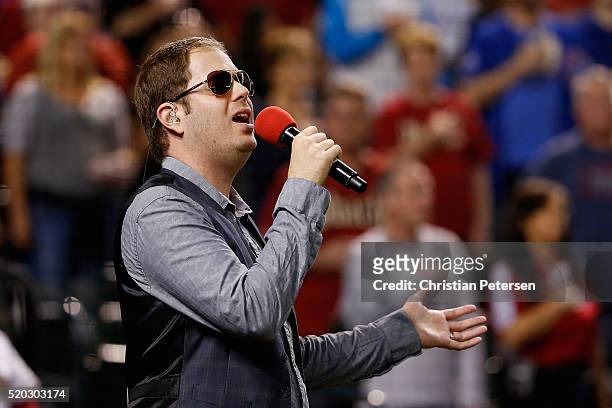 Former "American Idol" contestant Scott MacIntyre sings the American national anthem before the MLB game between the Arizona Diamondbacks and the...