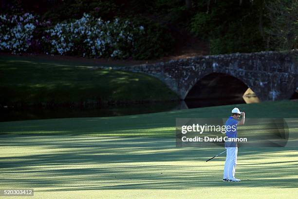 Jordan Spieth of the United States reacts to his third shot going into the water hazard on the 12th hole during the final round of the 2016 Masters...