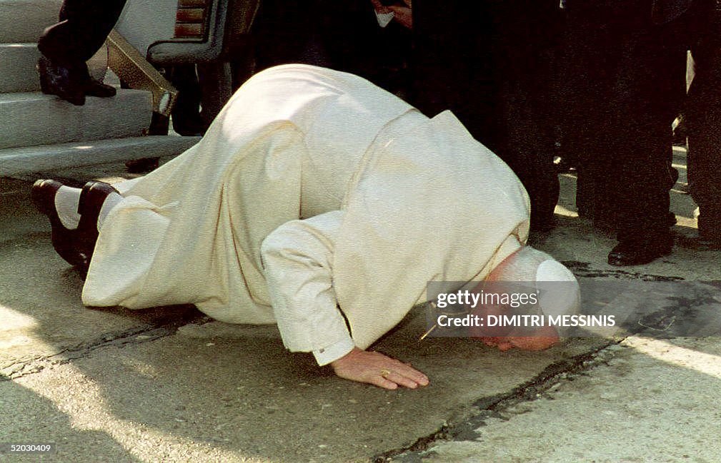 Pope John Paul II kisses the ground upon his arriv