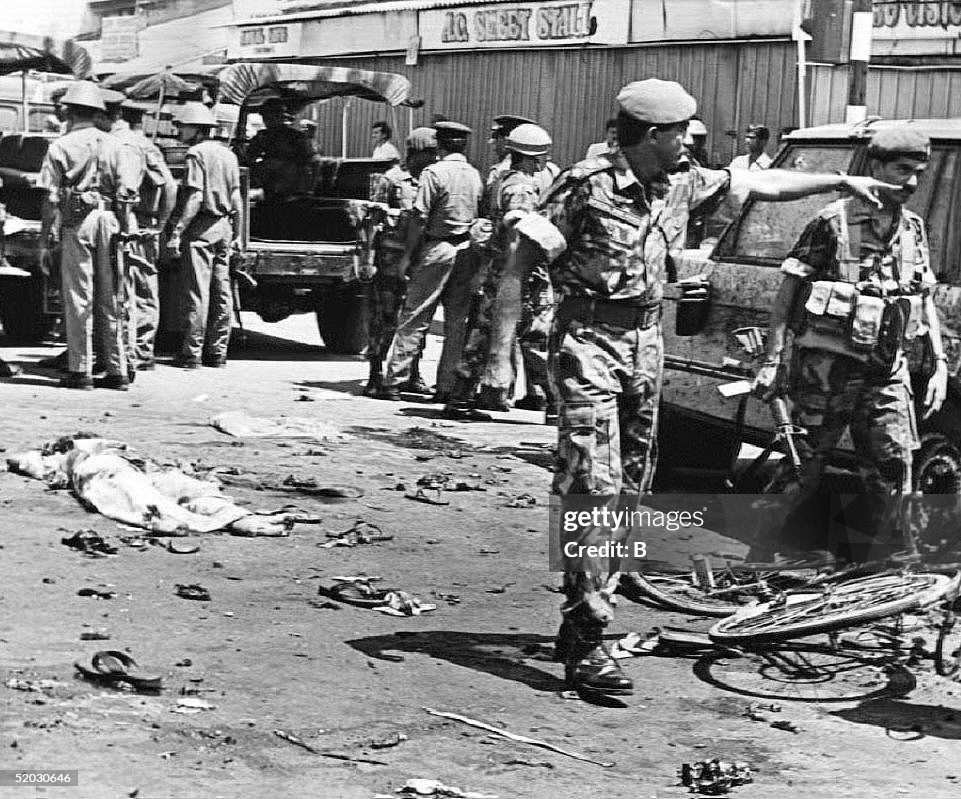 Soldiers clear the site after a bomb blast killed