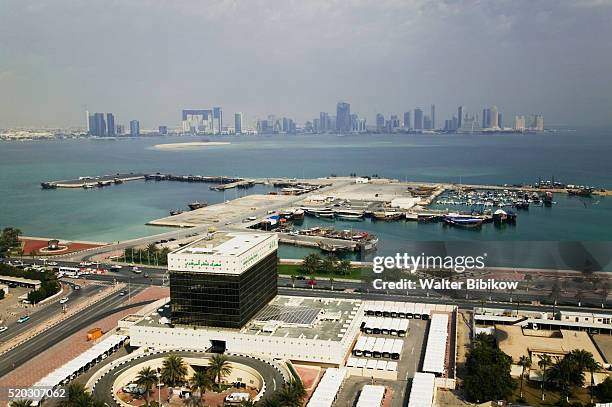 aerial over qatar central bank and doha port towards west bay - qatar central bank stock pictures, royalty-free photos & images