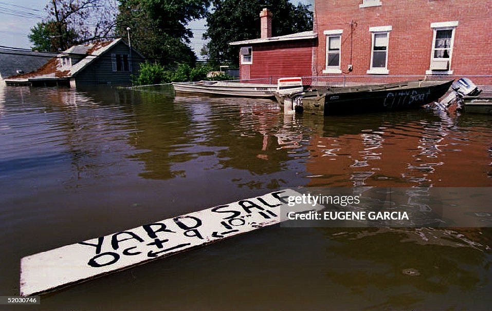 A sign floats in the downtown floodwaters of this