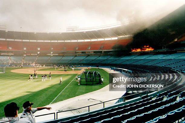 Fire rips through luxury suites and part of the press box at Atlanta-Fulton County Stadium in Atlanta, Georgia, before the 20 July 1993 game between...