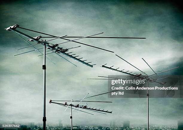 television antennas over city - television aerial stock pictures, royalty-free photos & images