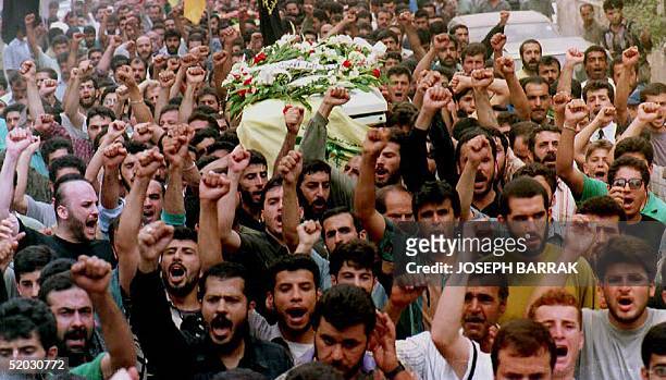 Members of the pro-Iranian Hezbollah shout anti-Israeli slogans in Beirut, Lebanon, 28 July 1993 during the funeral of Islamists killed in recent...
