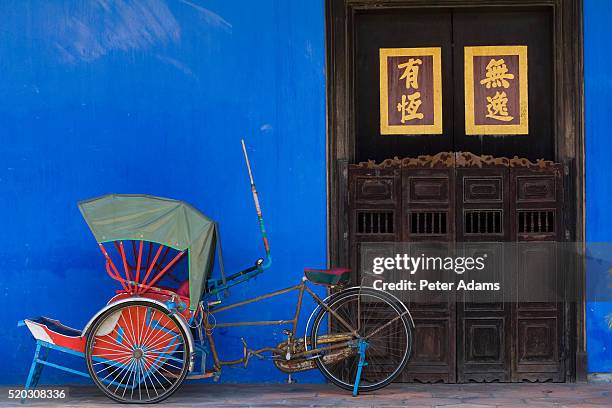 bicycle rickshaw by house entrance - pedicab stock pictures, royalty-free photos & images