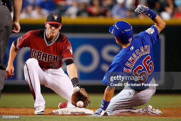 Infielder Nick Ahmed of the Arizona Diamondbacks catches the ball late as Munenori Kawasaki of the Chicago Cubs steals second base during the ninth...