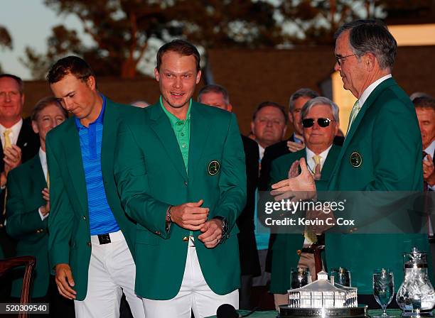 Jordan Spieth of the United States presents Danny Willett of England with the green jacket as Chairman of Augusta National, William Porter Payne...