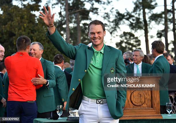 England's Danny Willett waves after receiving his Green Jacket at the end of the 80th Masters Golf Tournament at the Augusta National Golf Club on...
