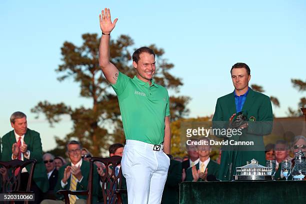 Danny Willett of England celebrates winning during the green jacket ceremony with Jordan Spieth of the United States during the final round of the...