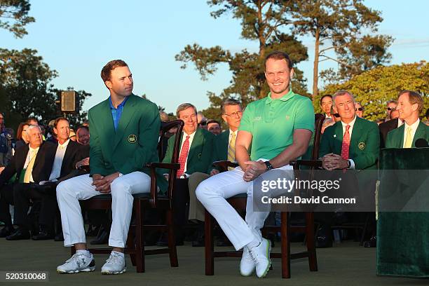 Danny Willett of England celebrates winning during the green jacket ceremony with Jordan Spieth of the United States during the final round of the...