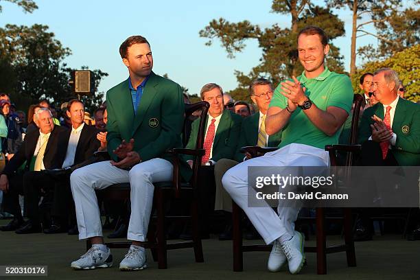 Danny Willett of England celebrates winning during the green jacket ceremony with Jordan Spieth of the United States after the final round of the...