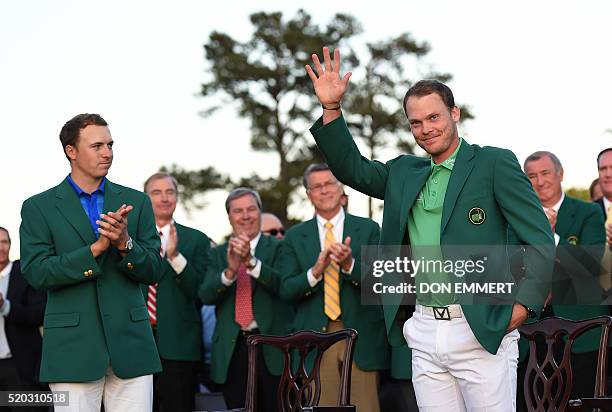 Golfer Jordan Spieth applauds as England's Danny Willett waves wearing his Green Jacket at the end of the 80th Masters Golf Tournament at the Augusta...