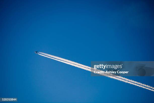 a plane flying over ambleside, uk. - sunset with jet contrails stock pictures, royalty-free photos & images