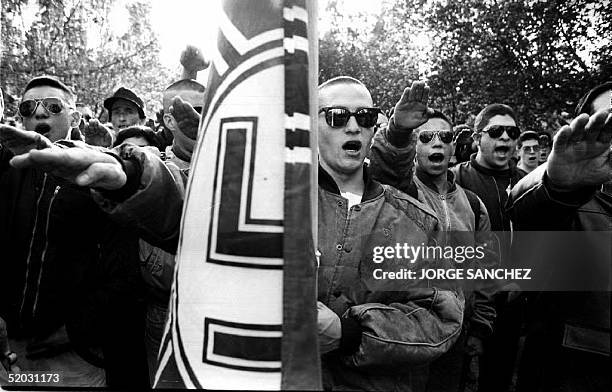 Chilean skinheads belonging to a local neo-nazi group give the nazi salute 05 September 1993 during a gathering at the General Cemetary as they...