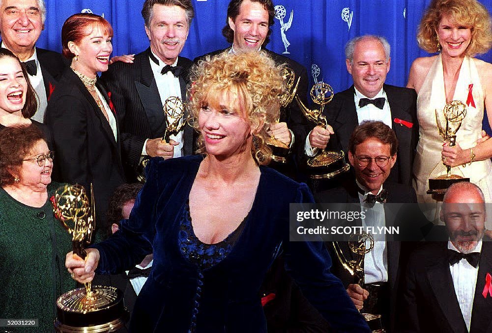 Actress Kathy Baker walks in front of the cast of