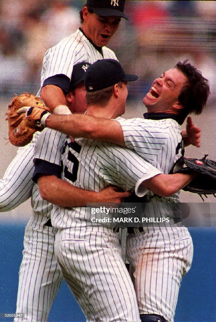 New York Yankees pitcher Jim Abbott (C) is grabbed