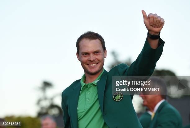 England's Danny Willett waves wearing his Green Jacket at the end of the 80th Masters Golf Tournament at the Augusta National Golf Club on April 10...