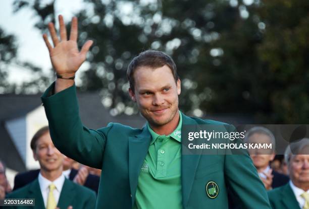 England's Danny Willett waves wearing the Green Jacket at the end of the 80th Masters Golf Tournament at the Augusta National Golf Club on April 10...
