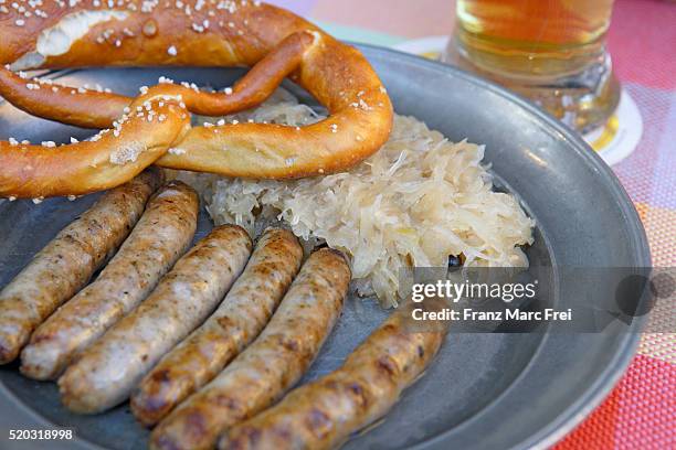 meal of bratwurst and sauerkraut - deutsche küche stock-fotos und bilder