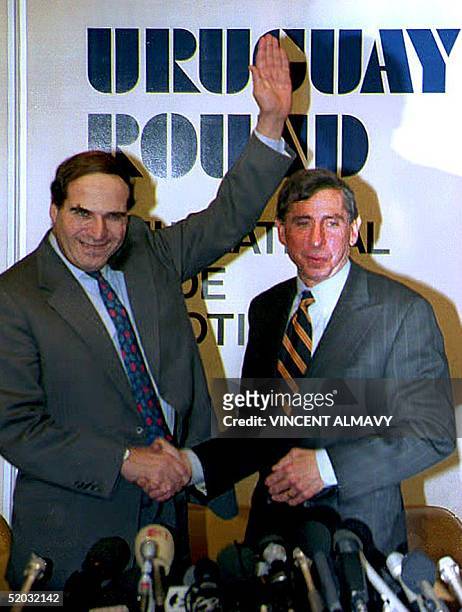 Trade Representative Mickey Kantor and EC Trade Commissioner Sir Leon Brittan shake hands, 14 December 1993, after announcing at a joint press...