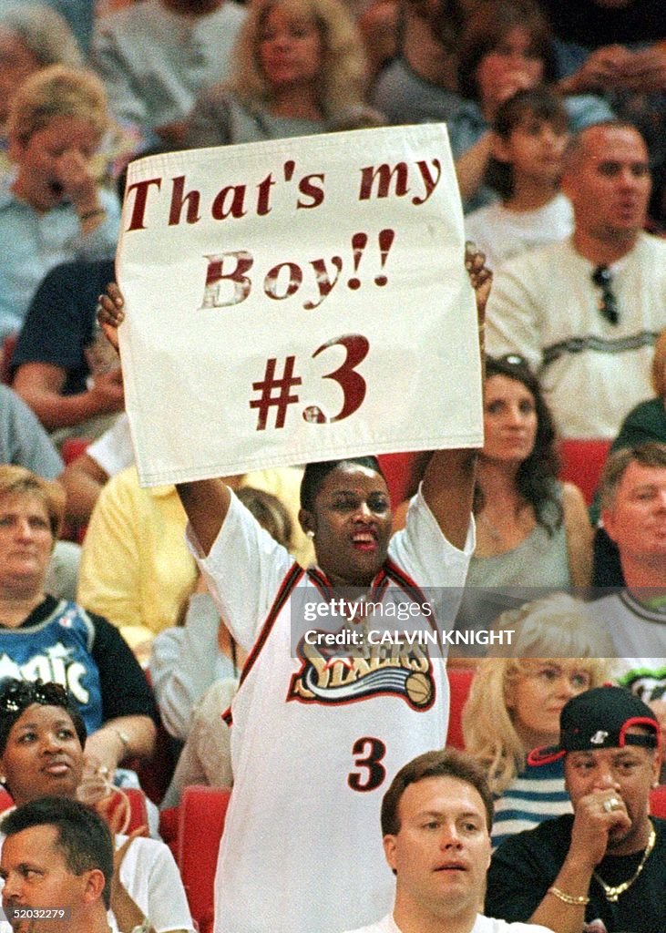 Ann Iverson holds a sign up on mothers day for her