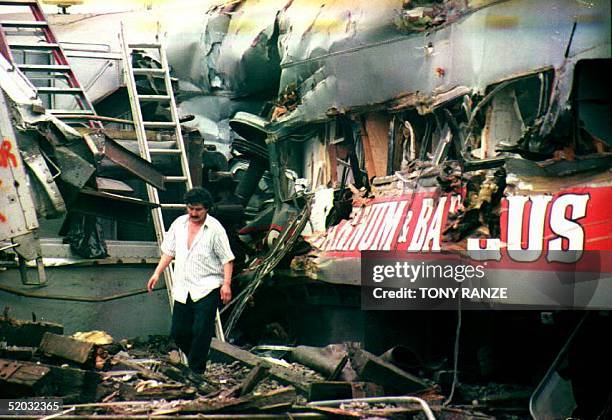 Man walks past a damaged car from the Ringling Brothers and Barnum & Bailey Circus train after it derailed early 13 January 1994 in Florida....