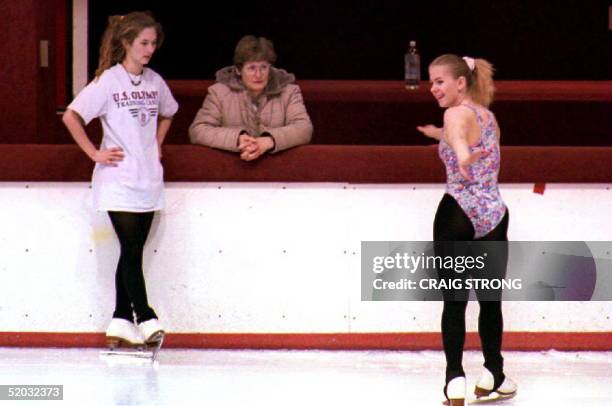 Figure skater Tonya Harding skates near mother Sandy Golden and training partner Angela Meduna during a workout 21 January 1994 as allegations...