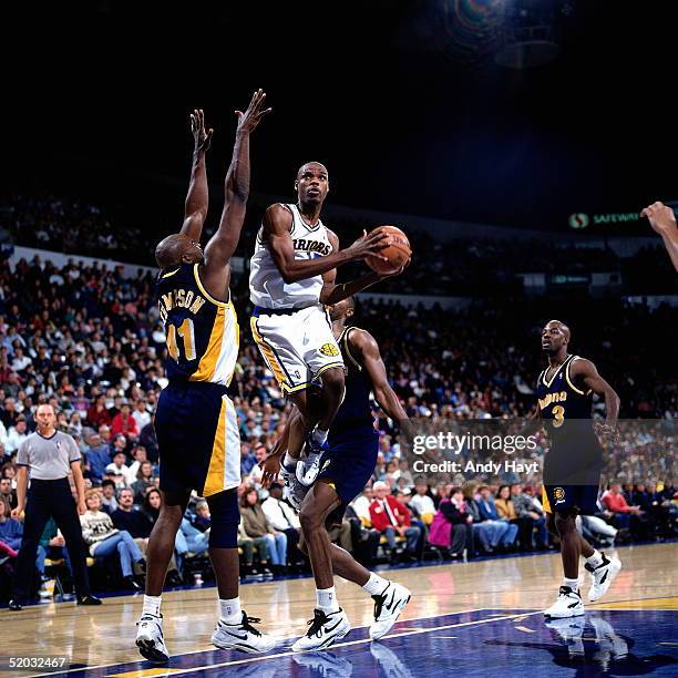 Latrell Sprewell of the Golden State Warriors drives to the basket against the Indiana Pacers during an NBA game on December 3, 1994 at the The Arena...