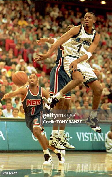 Orlando Magic guard Anfernee Hardaway takes to the air to make a pass after New Jersey Nets foreword Chris Morris applied pressure during the second...