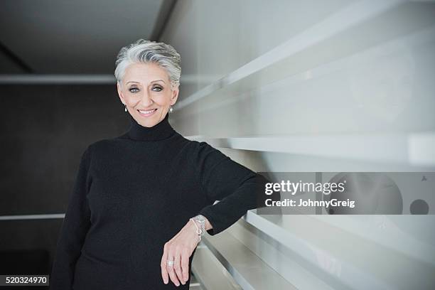 candid portrait of mature businesswoman in modern office - older woman short hair stock pictures, royalty-free photos & images