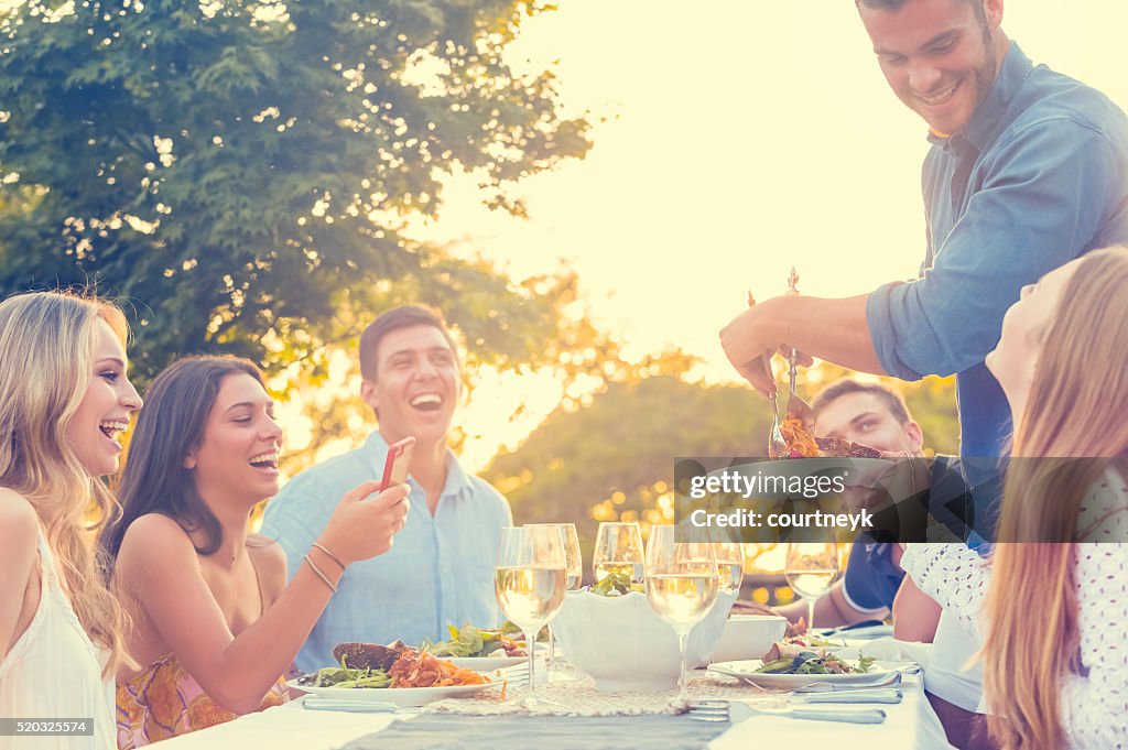 Group of friends having a meal outdoors.