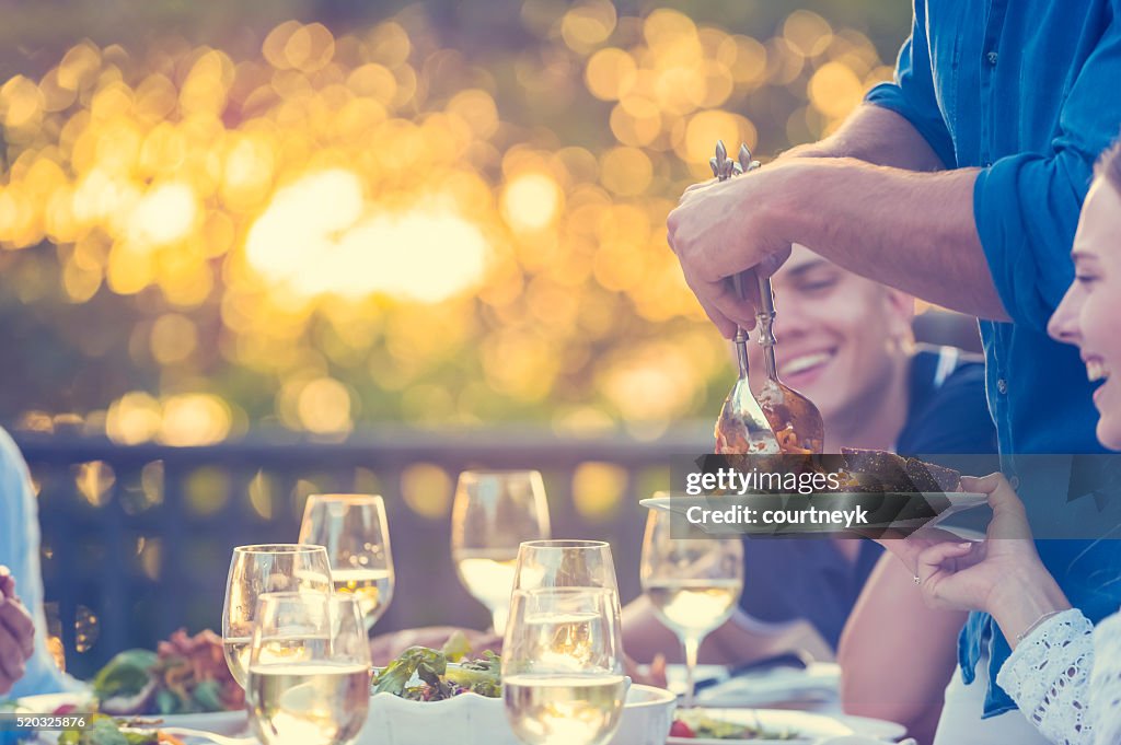 Group of friends having a meal outdoors.